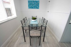 Bright dining room with comfortable seating for 6.