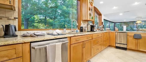 The main kitchen overlooks the pond and the Summer Kitchen.