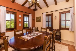 The dining room with traditional decoration on the furniture and the lighting