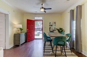Dining area w/ high top table, 6 designer stools, lounge chair, & natural light