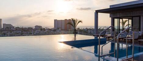 Relax watching the sunset over the ocean from the rooftop pool.