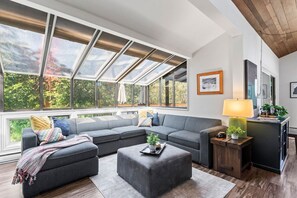 Enjoy the spacious sun room/great room.  Beautiful views of the forest while you sit and enjoy the fire after a fun day on the slopes.