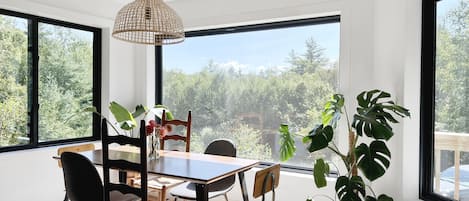 Picture windows let abundant light into the dining and living space