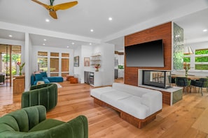 Large living room entertainment area with swivel chairs.  Design by CB2. 