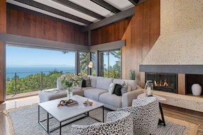 Grand living room with sweeping ocean views and cozy fireplace