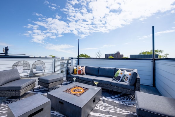 4th Floor: Rooftop deck a fire pit with outdoor lounging surrounded by city and neighborhood views. Rooftop also features yard games like corn hole and giant Connect-Four.