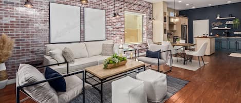 Stunning living room with abundance of natural light, featuring multiple seating, smart TV, fireplace, remote-controlled shades, and seamlessly connected to the dining area.