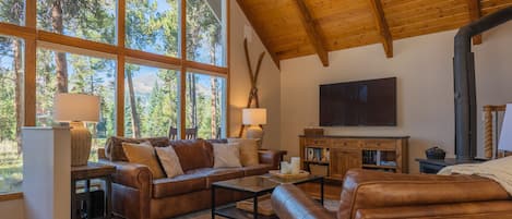 Bright & cozy living area with wood burning stove, large TV & Sonos sound system