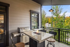 The firepit table on the balcony is a great place to catch up with your travel companions while you prepare dinner on the grill.