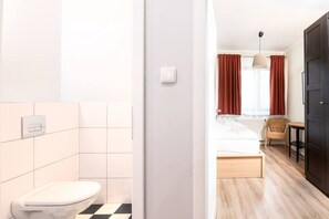 Bright bedroom with bathroom in a cozy holiday apartment near the beach.