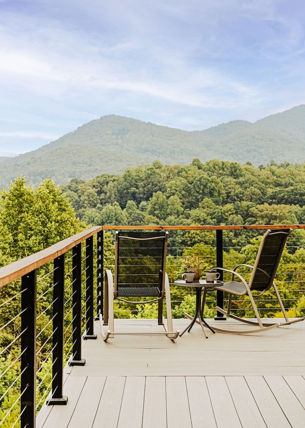 Start your day with coffee and mountain views from this peaceful deck perch, rockers included.