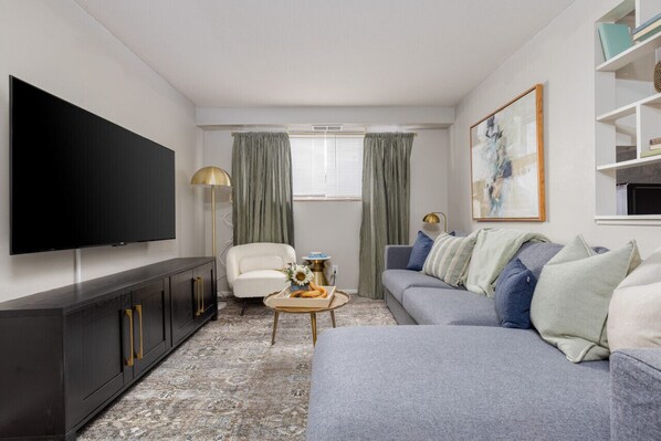Unwind on this cozy sofa and immerse yourself in entertainment with the 55" TV