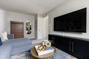 Unwind on this cozy sofa and immerse yourself in entertainment with the 55" TV