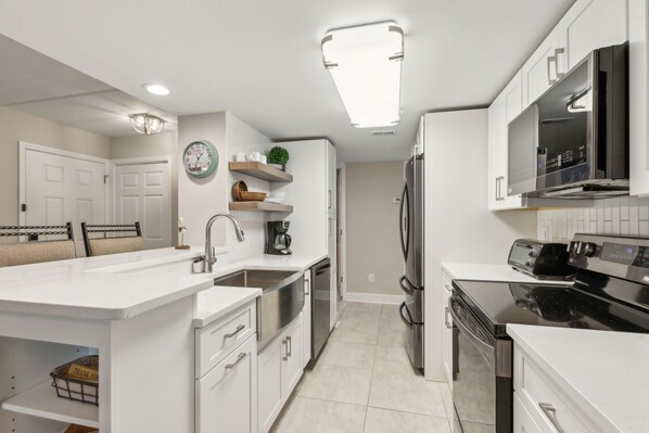 Fully Renovated Kitchen with Open Shelving, Gorgeous Quartz Countertops, and Stainless Steel Appliances