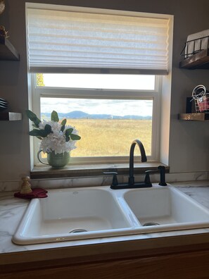 Spacious views out every window of neighboring fields amd mountains.