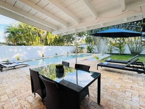 Poolside Bliss: Enjoy sunny days by the pool, with a perfect spot for dining al fresco.