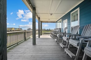 Front deck that wraps around the house with plenty of seating to watch and listen to the ocean.