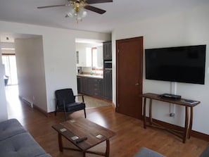 Living room view towards TV and kitchen