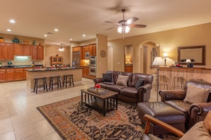 The open concept great room has a large kitchen, sitting area and island.