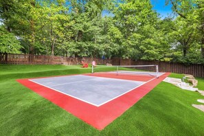 Our backyard oasis is sure to excite the whole crew with amenities such as a FULL-SIZED PICKLE BALL COURT, a putting green, an outdoor kitchen, a 6-person hot tub, and more!