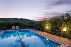 As the sun bids adieu, our pool area transforms into a dreamy haven.