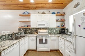 Fully stocked kitchen is primed for hosting BBQ cookouts and crafting delightful meals.