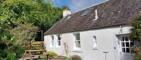 The semi-detached cottage is accessed through a shared front door.