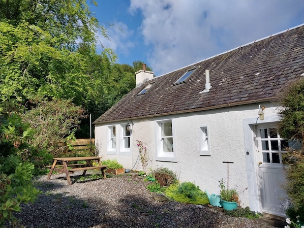 The semi-detached cottage is accessed through a shared front door.