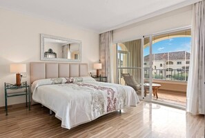Lovely master bedroom with a double bed and a door to the beautiful gallery