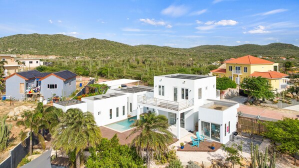 Stunning view showcasing the Villa  - Inviting pool area - The lush natural surroundings of San Fuego - Greenery everywhere