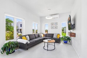 Outstanding Living Area of the villa in Santa Cruz Aruba - Comfy Sofas - Stylish furniture arrangement providing comfort and a cohesive look - Smart TV and Netflix - Indoor plants for a touch of natural elegance