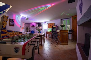 Disco room with TV, Bar, foosball table, arcade games, flipper, fire place...