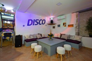 Disco room with TV, Bar, foosball table, arcade games, flipper, fire place...