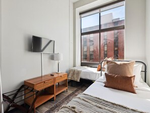 First Bedroom with natural light and two twin beds