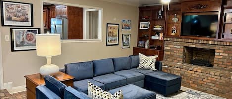 Open living room floor plan with 75" smart tv. Sofa converts to Queen size bed 