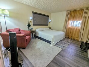 Bedroom #1 with king-size bed and chair.