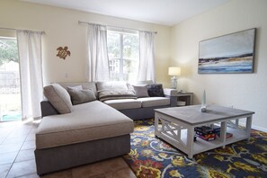 Nautical-themed living area with L-shaped sofa and Smart TV