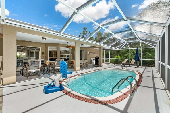 Heated pool in private back lanai surrounded by palm trees!